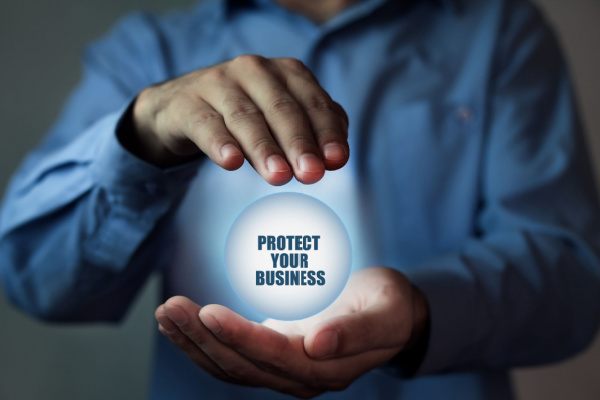 Hands holding an orb with the phrase Protect your Business
